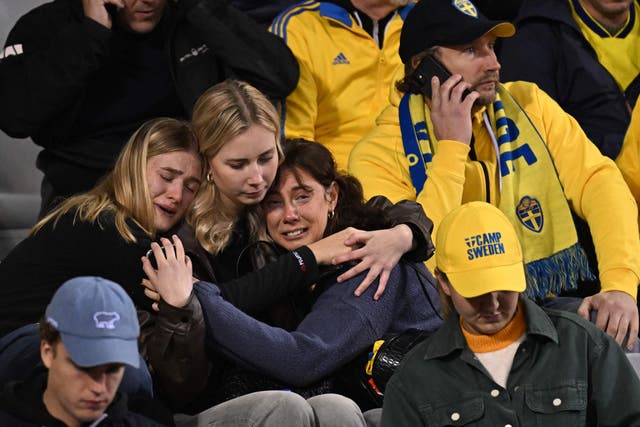 <p>Swedish supporters react as they wait in the stand during the Euro 2024 qualifying football match between Belgium and Sweden </p>