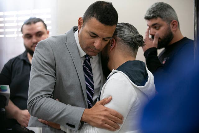 <p>Ahmed Rehab, left, executive director of the Chicago chapter of the Council on American-Islamic Relations,  embraces Odey Al-Fayoume, father of Wadea Al-Fayoume, on 15 October. </p>