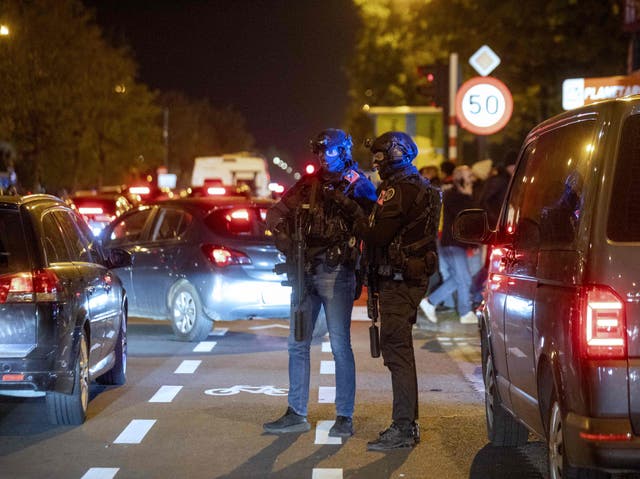 <p>Police officers stand guard as supporters leave the King Baudouin Stadium following the Euro 2024 qualifying football match between Belgium and Sweden in Brussels on October 16, 2023, after two Swedes were shot dead in an attack in Brussels</p>