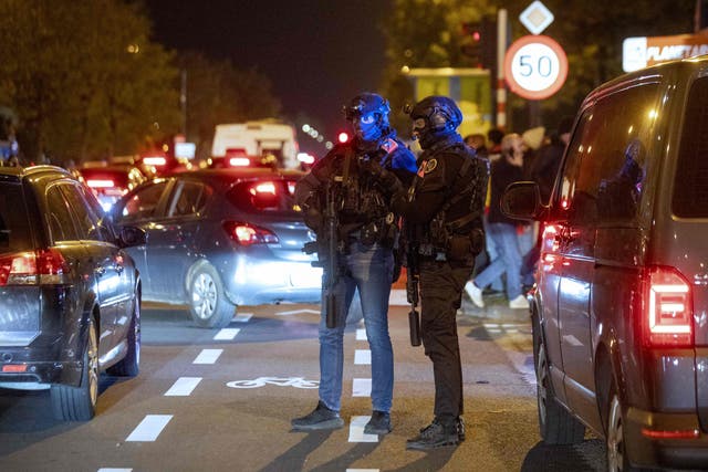 <p>Police officers stand guard as supporters leave the King Baudouin Stadium following the Euro 2024 qualifying football match between Belgium and Sweden in Brussels on October 16, 2023, after two Swedes were shot dead in an attack in Brussels</p>