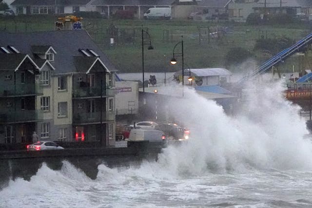 Waves crash against the sea wall in Tramore, County Waterford (Niall Carson/PA)