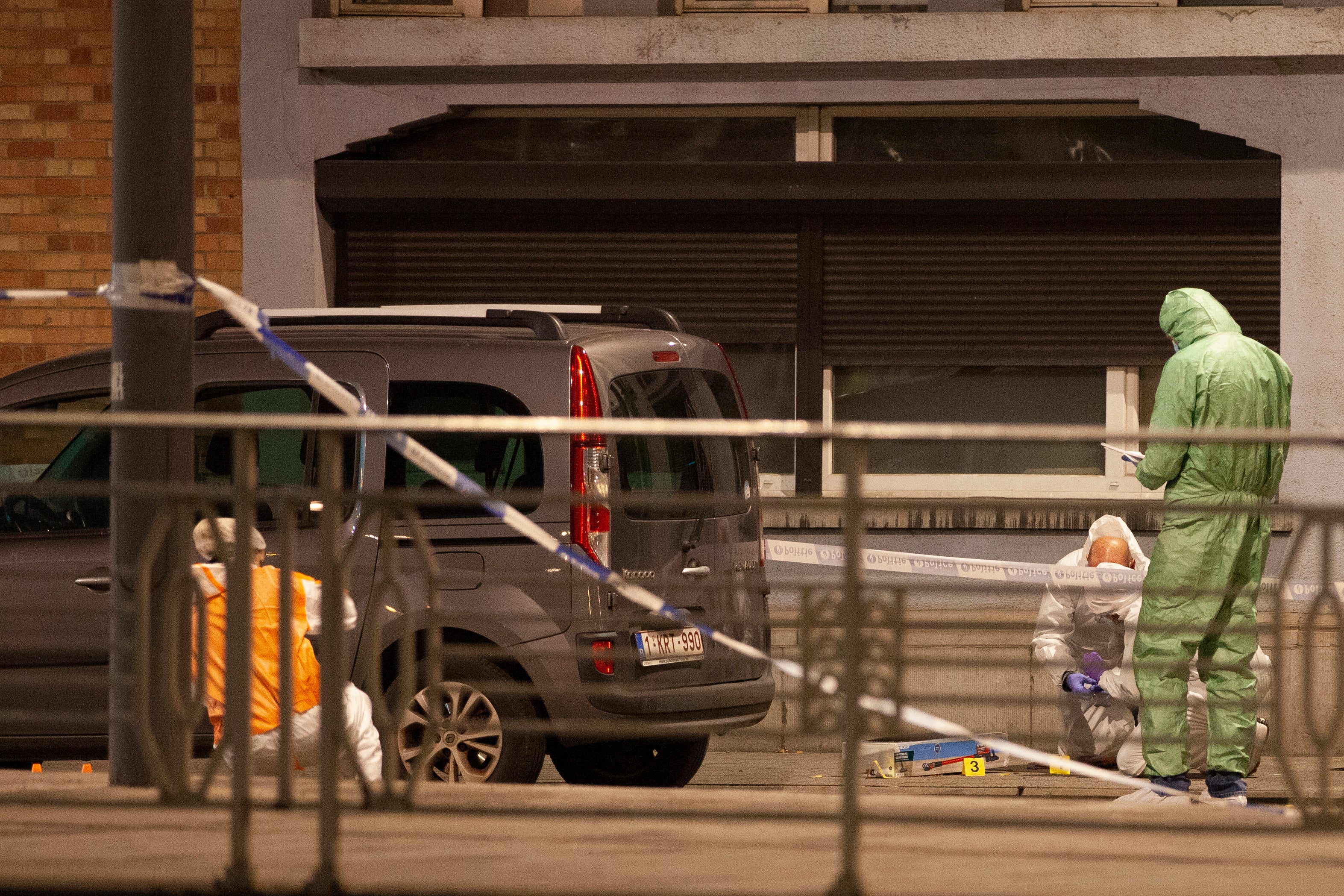 Police and inspectors work in an area where a shooting took place in the center of Brussels