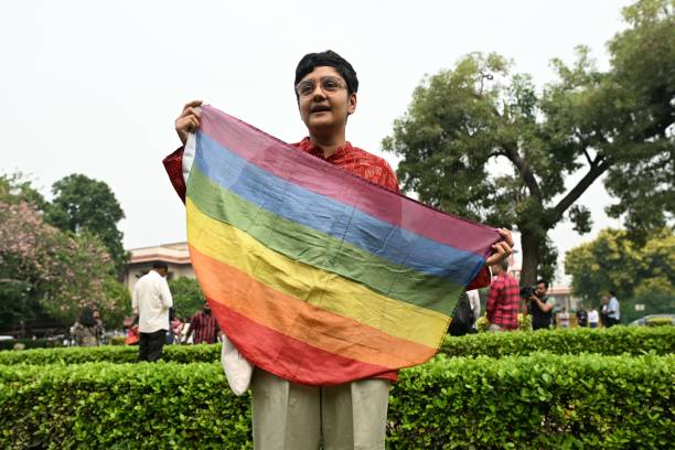 An activist holds a rainbow flag in the courtyard of India’s Supreme Court in New Delhi on 17 October 2023
