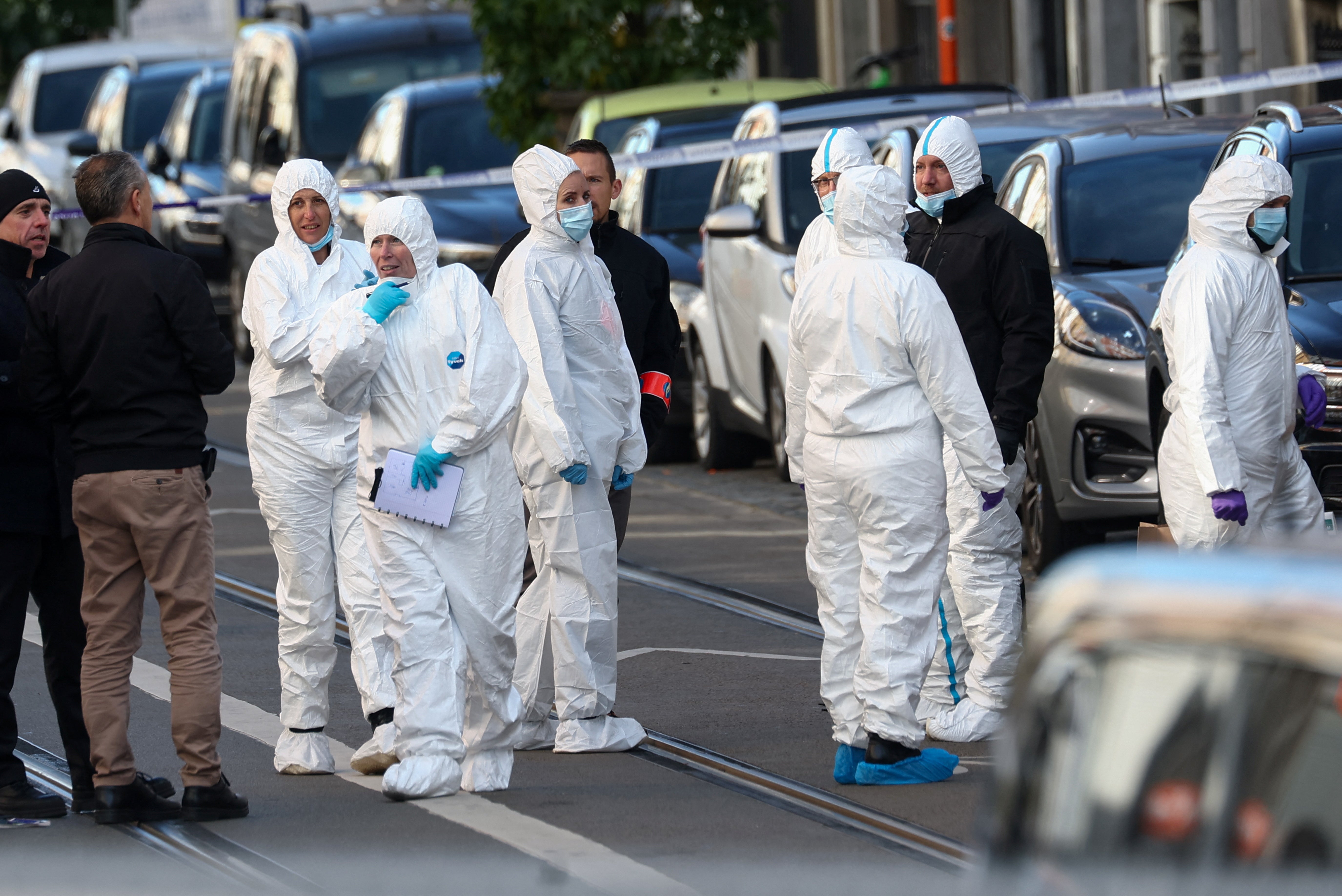 Officers work outside the site of a police operation against a deadly shooting suspect, in Schaerbeek