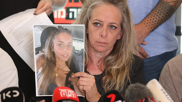 <p>Keren Shem holds up a picture of her daughter during a plea in Tel Aviv  </p>