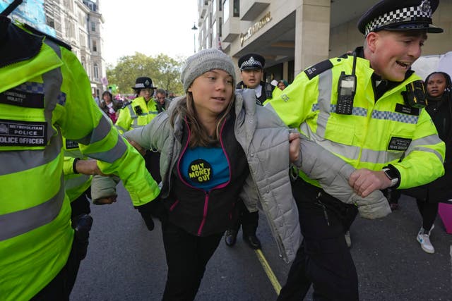 <p>Environmental activist Greta Thunberg is taken away by police officers during the Oily Money Out protest outside the Intercontinental Hostel, in London on Tuesday</p>
