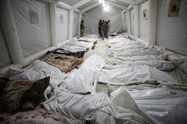 <p>Bodies of Palestinians killed by an explosion at the Ahli Arab hospital are gathered at the front yard of the al-Shifa hospital, in Gaza City, central Gaza Strip, Tuesday, Oct. 17, 2023. </p>