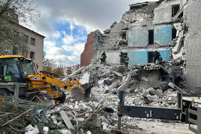 <p>The rescuers clearing debris to find the people under the rubble of a destroyed residential building, following a strike in Sloviansk</p>