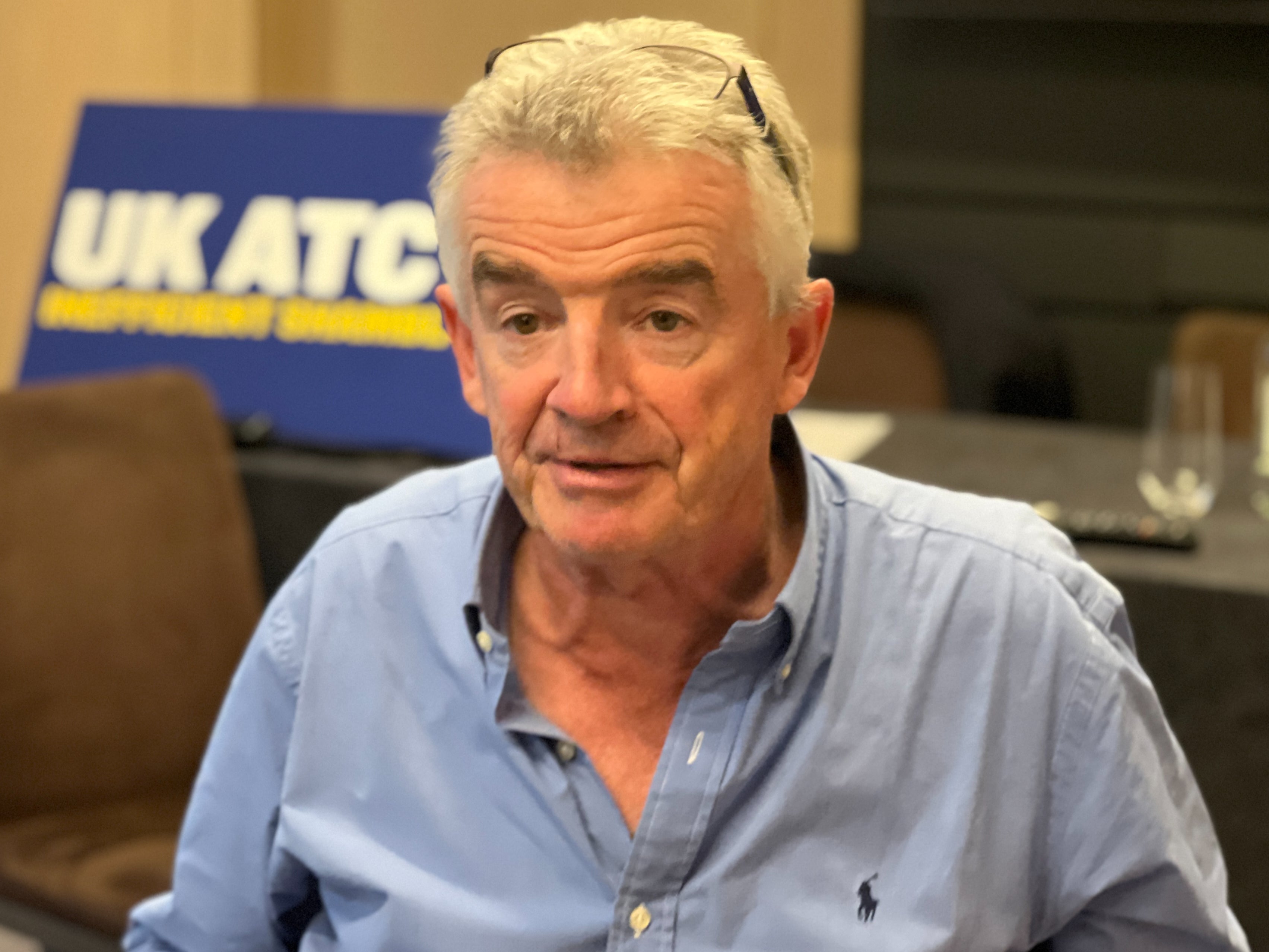 Michael O’Leary, chief executive of Ryanair, at a media event in London on 27 September 2023. The sign behind him reads “UK ATC: Inefficicent shambles”