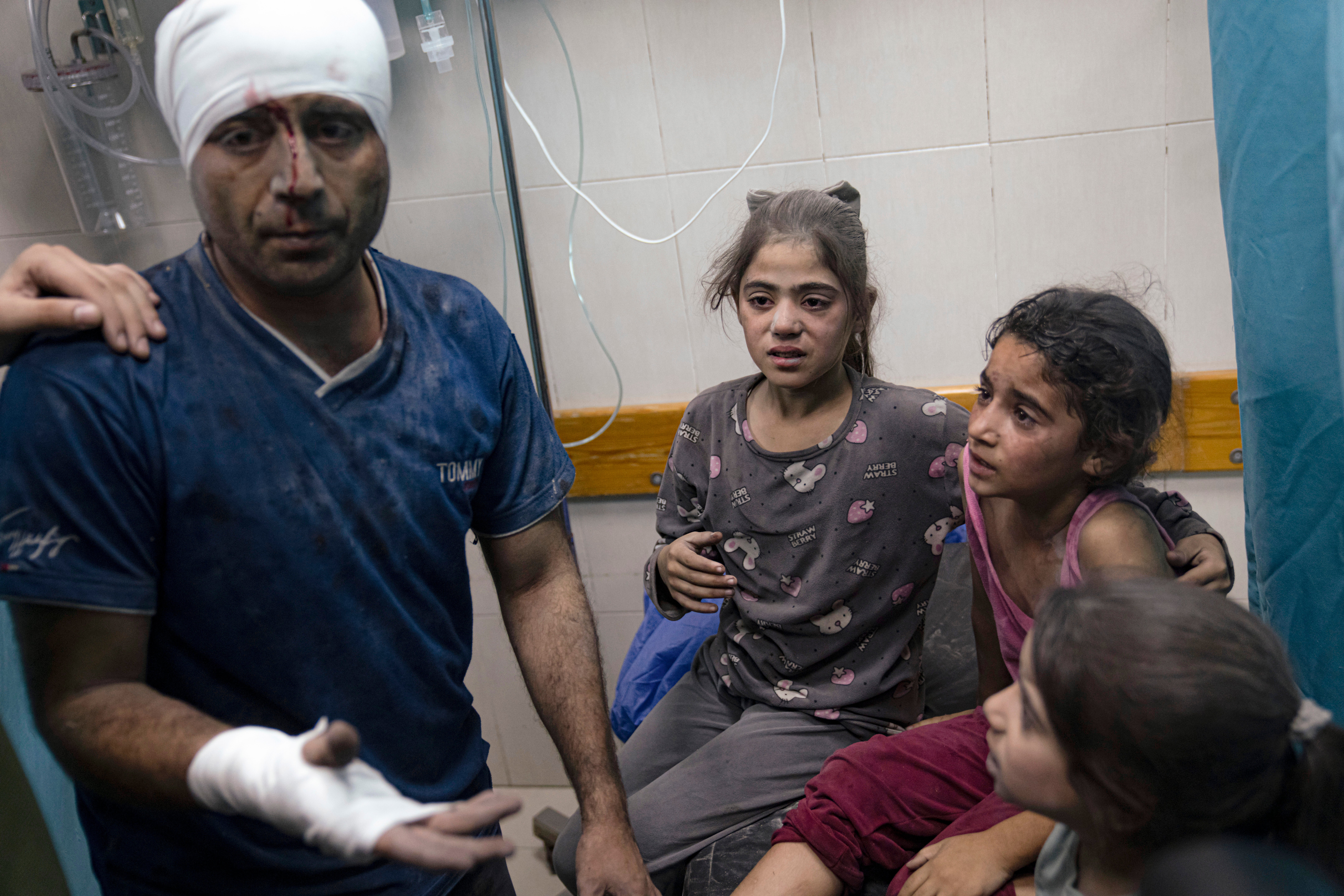Palestinians wounded in the Israeli bombardment are treated in a hospital in Khan Younis, southern Gaza