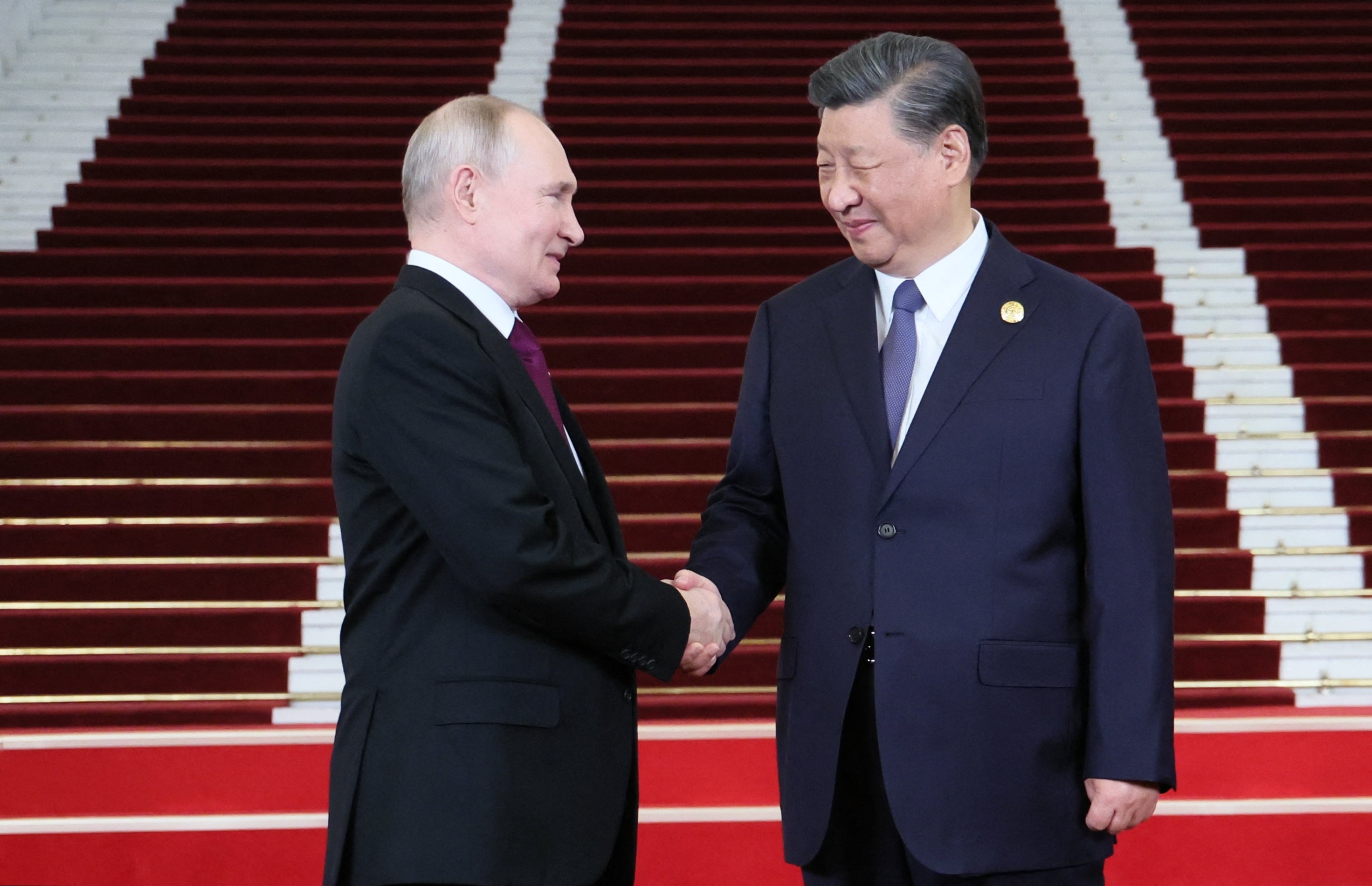 Russia's President Vladimir Putin and Chinese President Xi Jinping shaking hands during a welcoming ceremony at the Third Belt and Road Forum in Beijing
