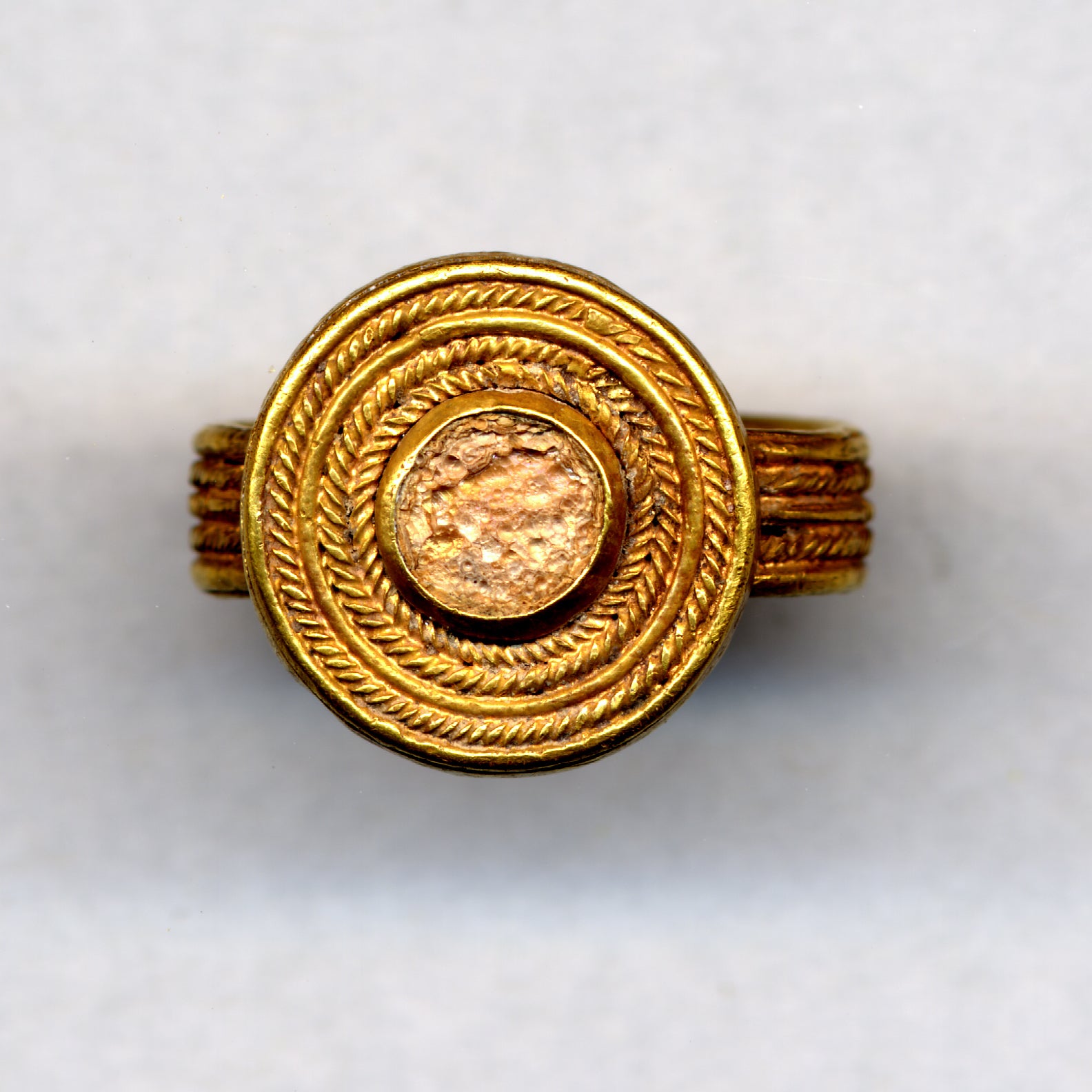A gold finger-ring with a glass setting, similar to the items missing from the museum collections