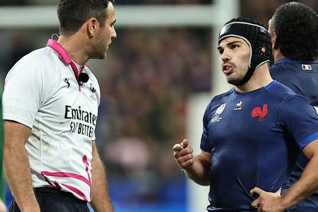 <p>France’s scrum-half and captain Antoine Dupont speaks with New Zealand referee Ben O’Keeffe</p>