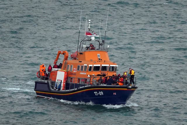 A group of people thought to be migrants being brought in to Dover, Kent (Gareth Fuller/PA)