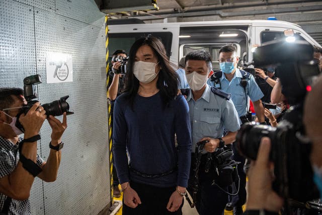 <p>File: Police officers escort Tsang Chi-kin off a police van at the district court on July 14, 2022 in Hong Kong </p>