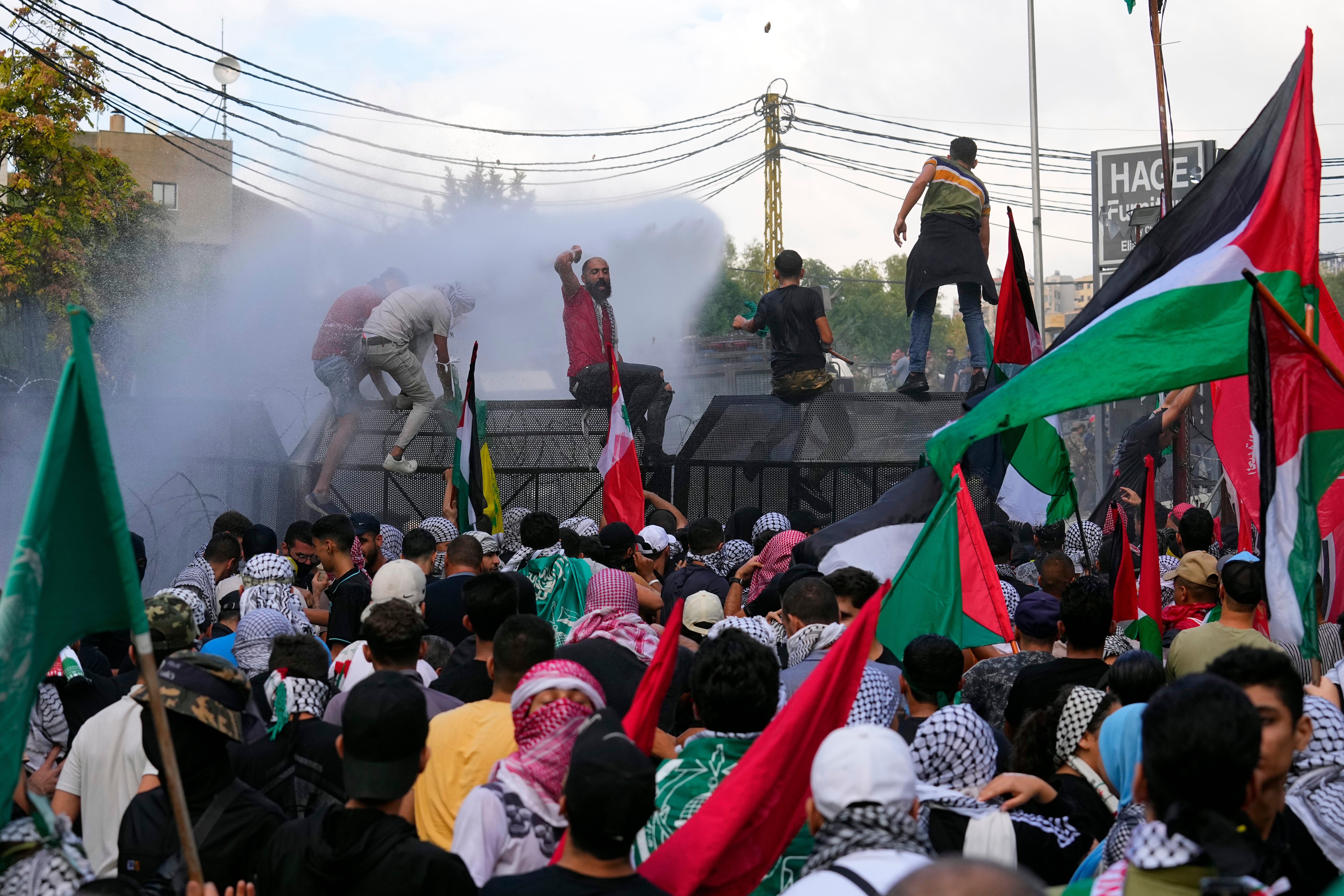 Lebanese riot police spray water canons at those protesting in solidarity with the Palestinian people