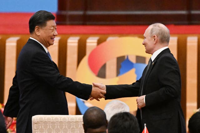 <p>Xi Jinping shakes hands with Vladimir Putin at the Belt and Road summit in the Great Hall of the People in Beijing</p>