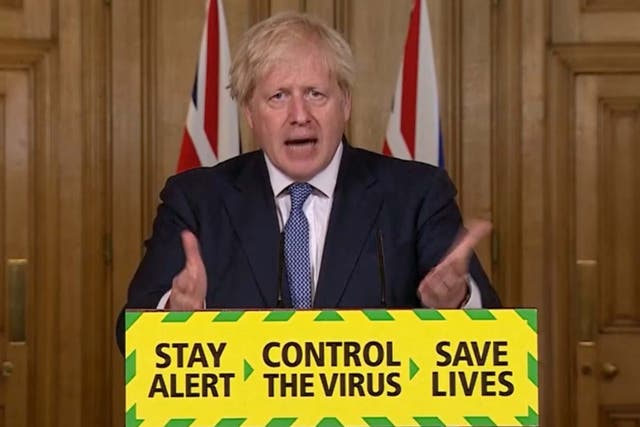 Prime minister Boris Johnson during a media briefing in Downing Street with the ‘stay alert’ messaging on his lectern in July 2020 (PA)