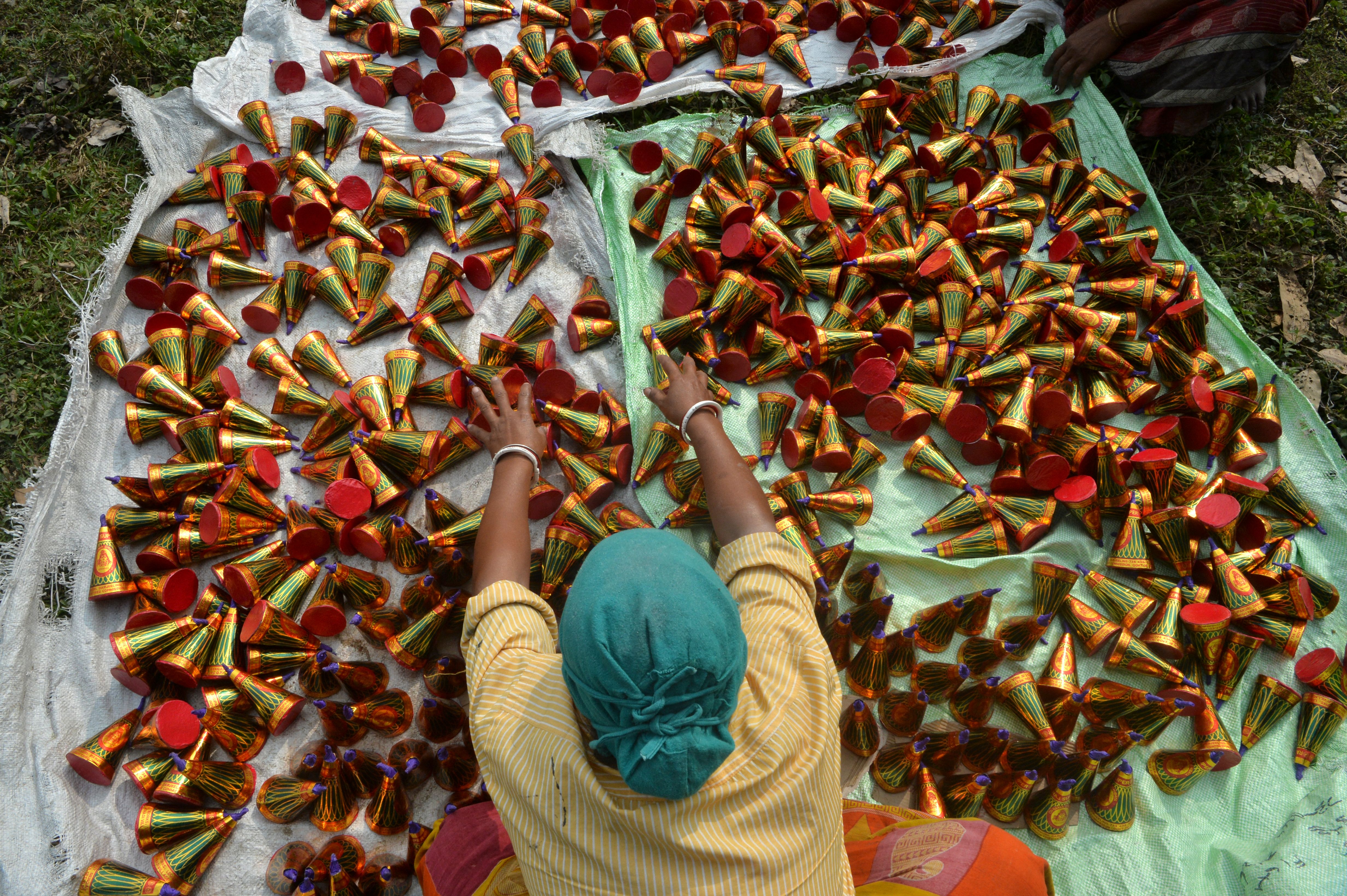 File A labourer works on eco-friendly crackers, which produce less smoke and contain less chemicals, at Raj firecracker factory in Liusipukuri village, on the outskirts of Siliguri in 2019
