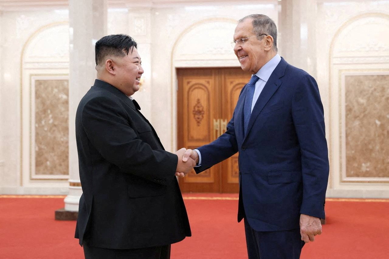 North Korean leader Kim Jong-un shakes hands with Russian foreign minister Sergei Lavrov during a meeting in Pyongyang
