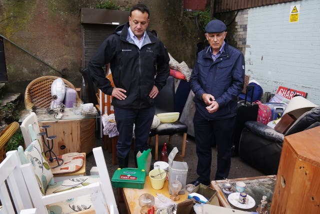 Taoiseach Leo Varadkar (left) observes the damage to a local charity shop on Main Street in Midleton, Co Cork, after Storm Babet, the second named storm of the season, swept in. Picture date: Thursday October 19, 2023.