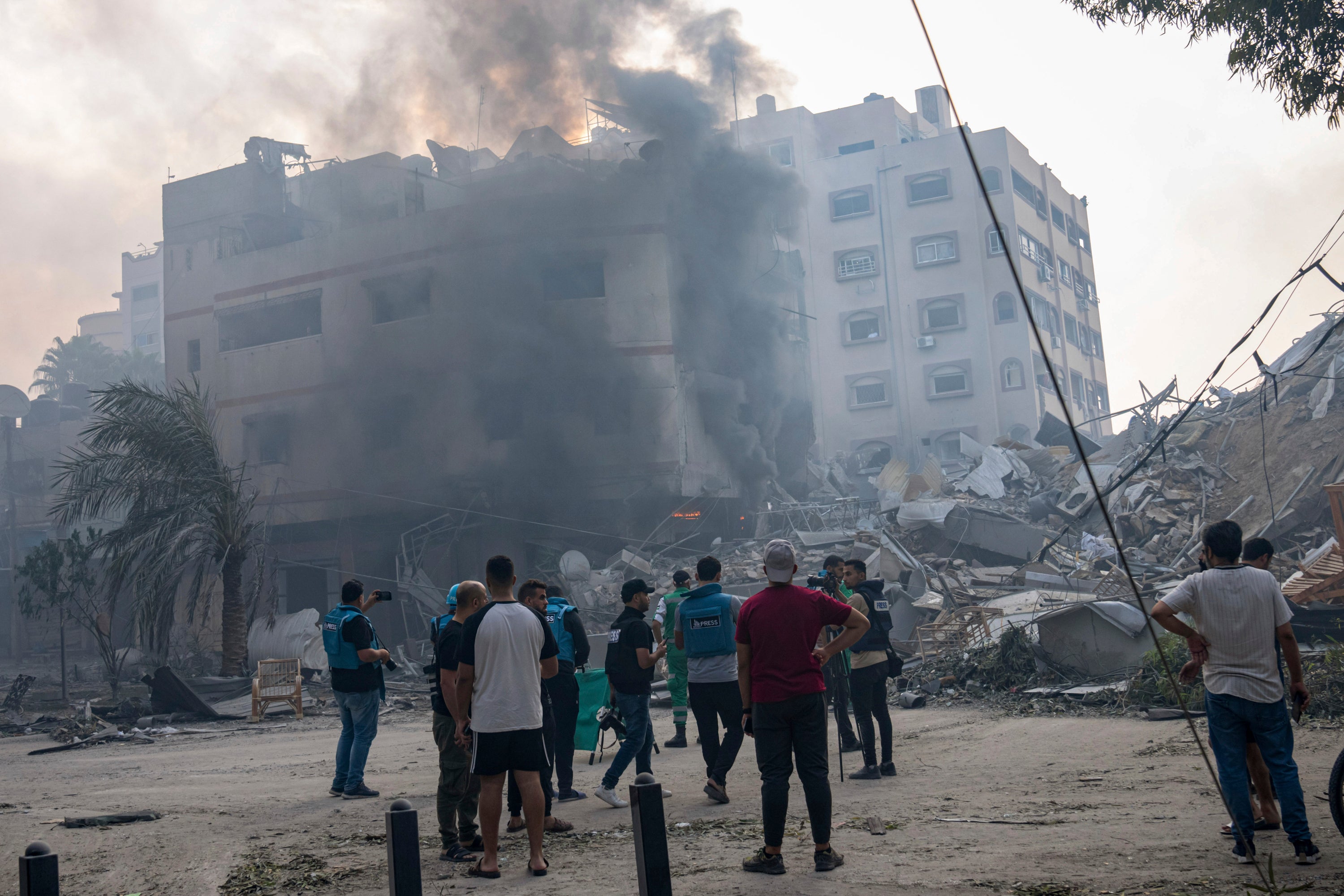 Palestinians inspect the rubble of a building in Gaza City after it was hit by an Israeli airstrike