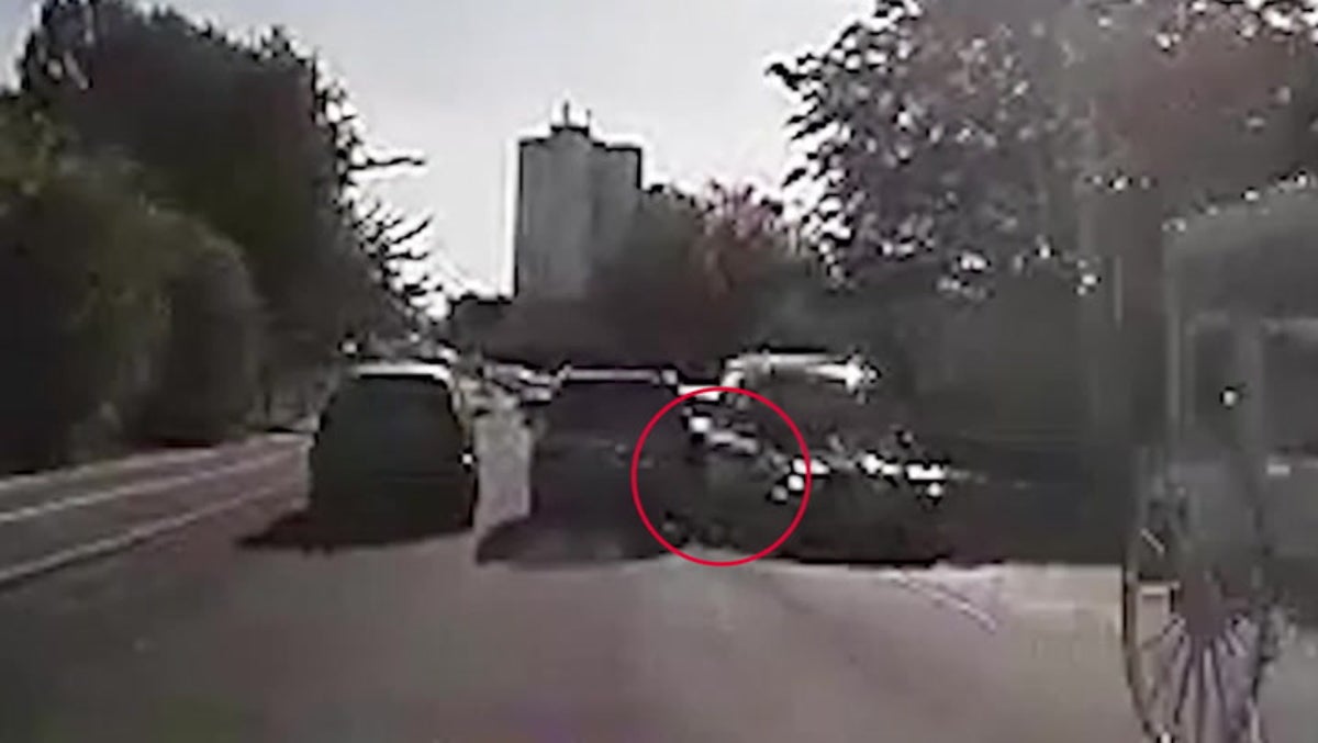 Watch: Speeding driver comes inches away from hitting funeral hearse