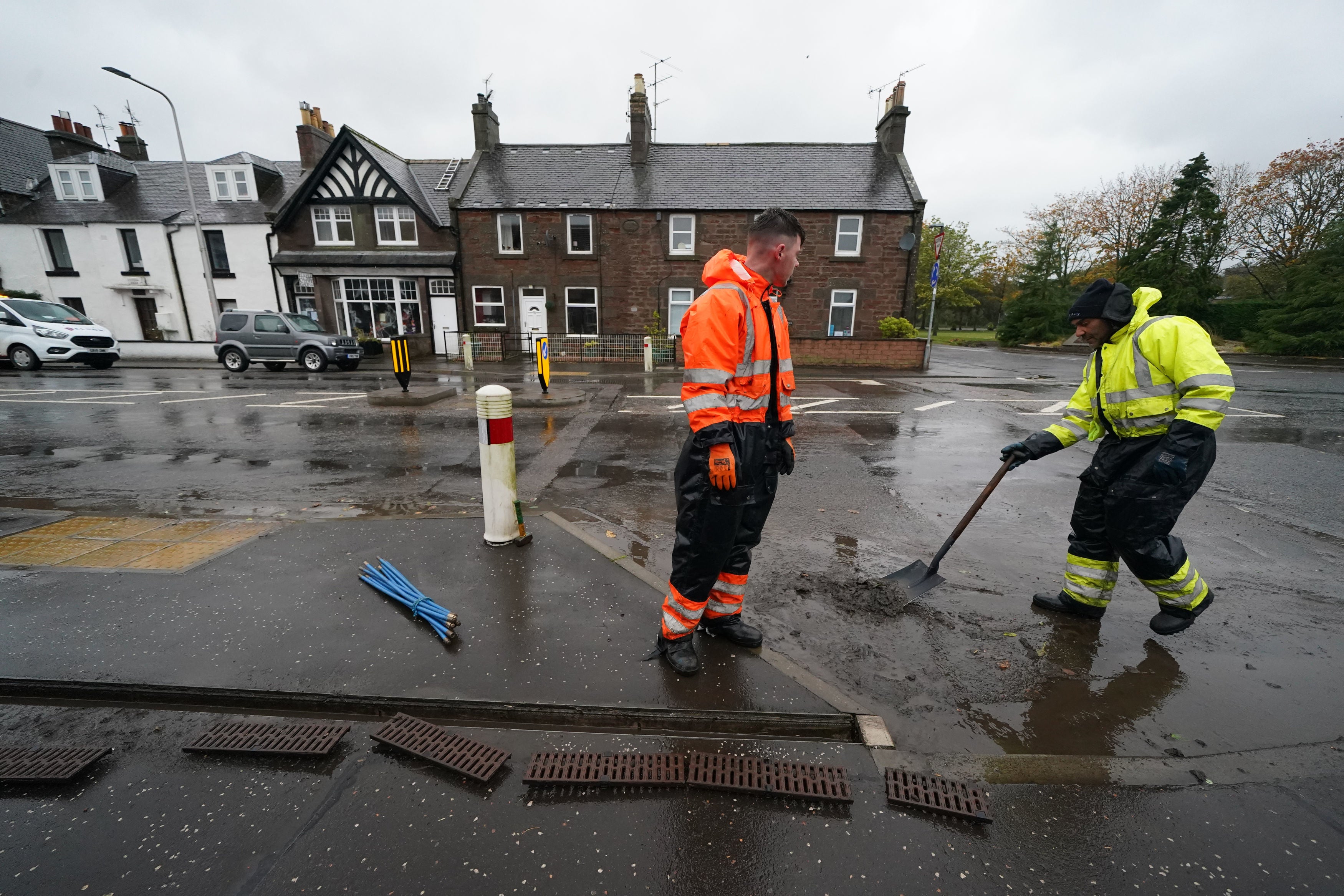 Workmen clear the drains in the village of Edzell, Scotland