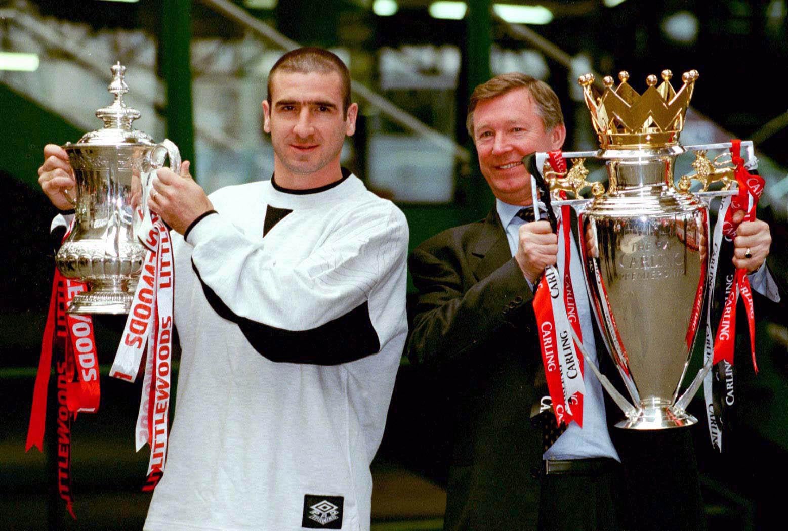 Cantona with the FA Cup and manager Alex Ferguson with the Carling Premiership trophy in May 1996