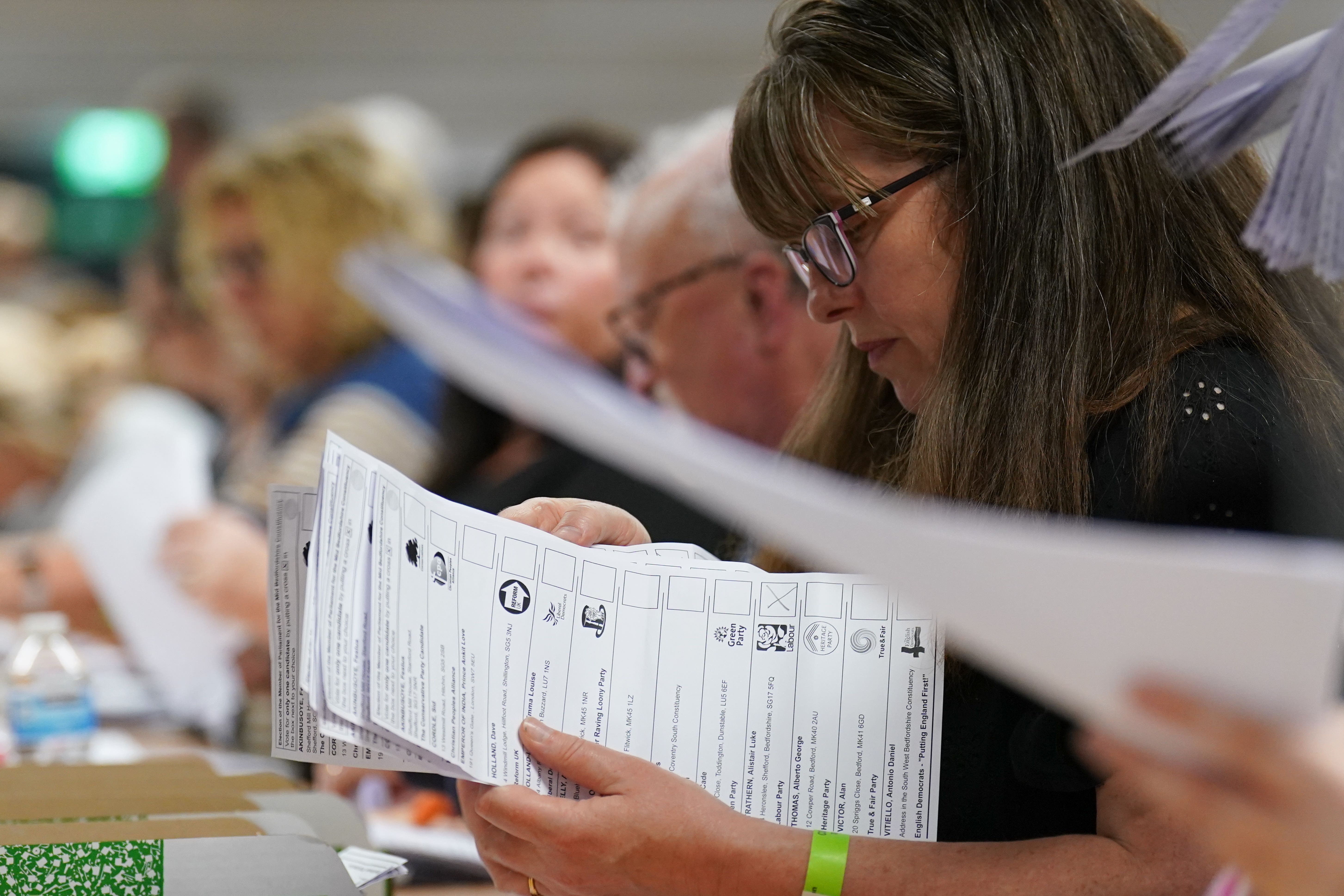 Votes are counted at Priory House in Chicksands, Bedfordshire during the count for the Mid Bedfordshire by-election (PA)