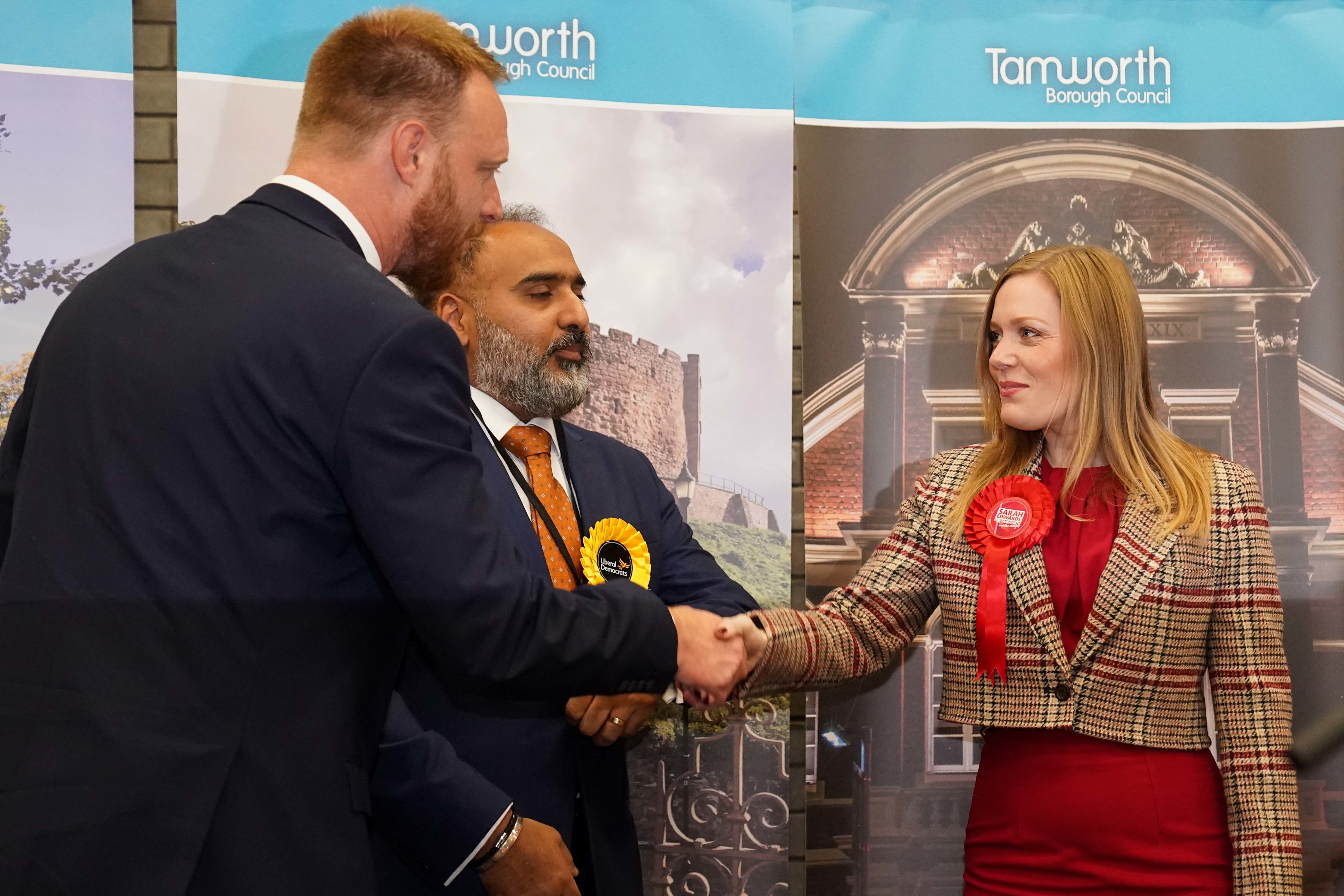 Sarah Edwards of Labour shakes the hand of Conservative candidate Andrew Cooper after she was declared the Member of Parliament for Tamworth following Thursday's by-election