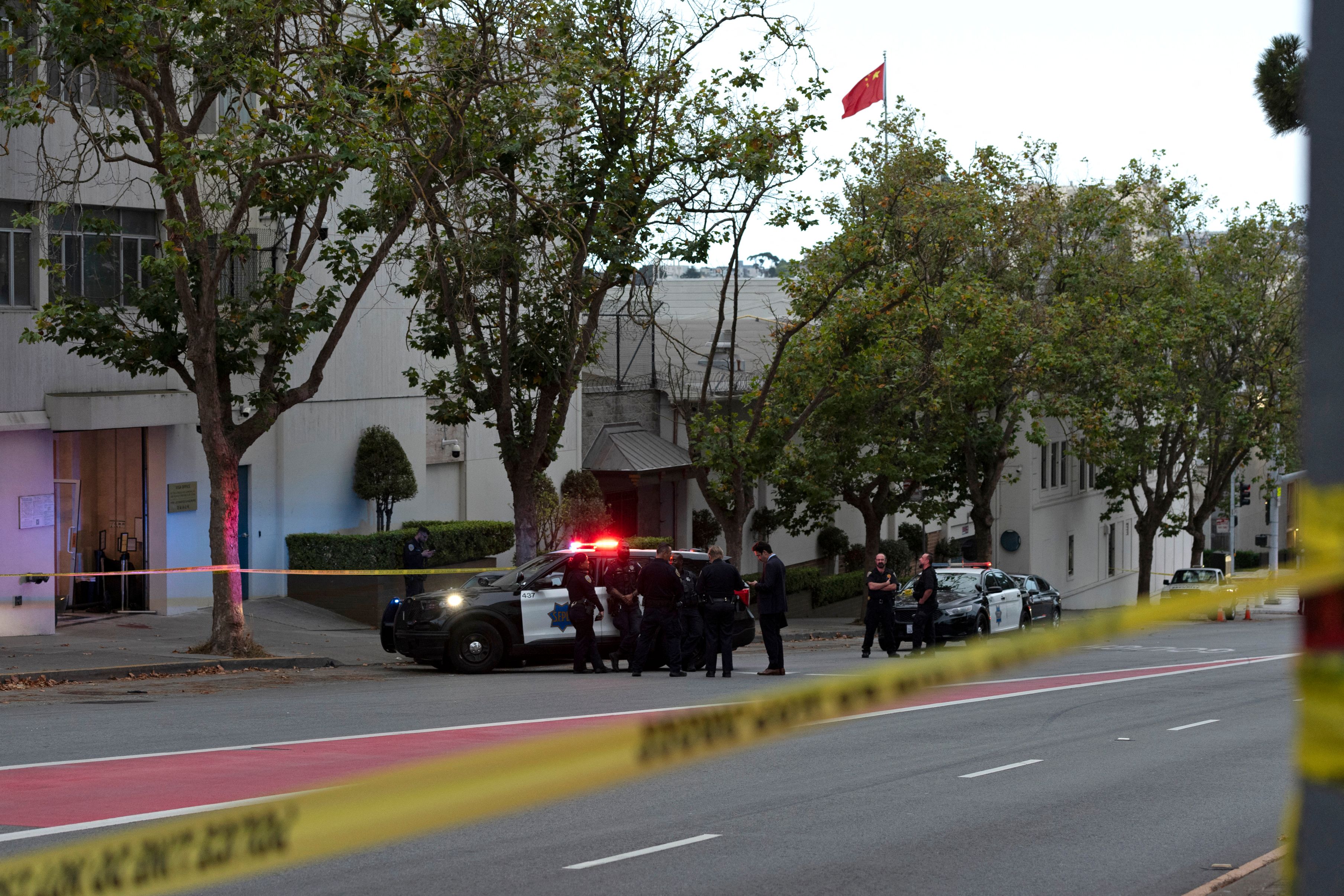Police officers are seen outside the visa office of the Chinese consulate, where earlier a vehicle crashed into the building, in San Francisco, California, on 9 October 2023
