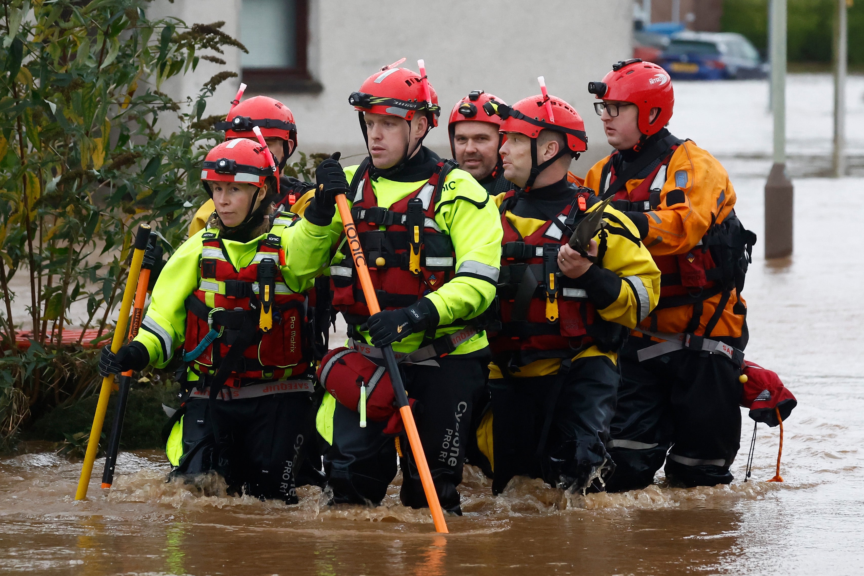 Members of a rescue team wade through the flood waters in Brechin after hundreds of homes were evacuated