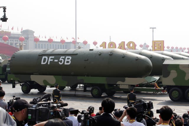 <p>Military vehicles carrying DF-5B intercontinental ballistic missiles travel past Tiananmen Square during the military parade marking the 70th founding anniversary of the People’s Republic of China</p>