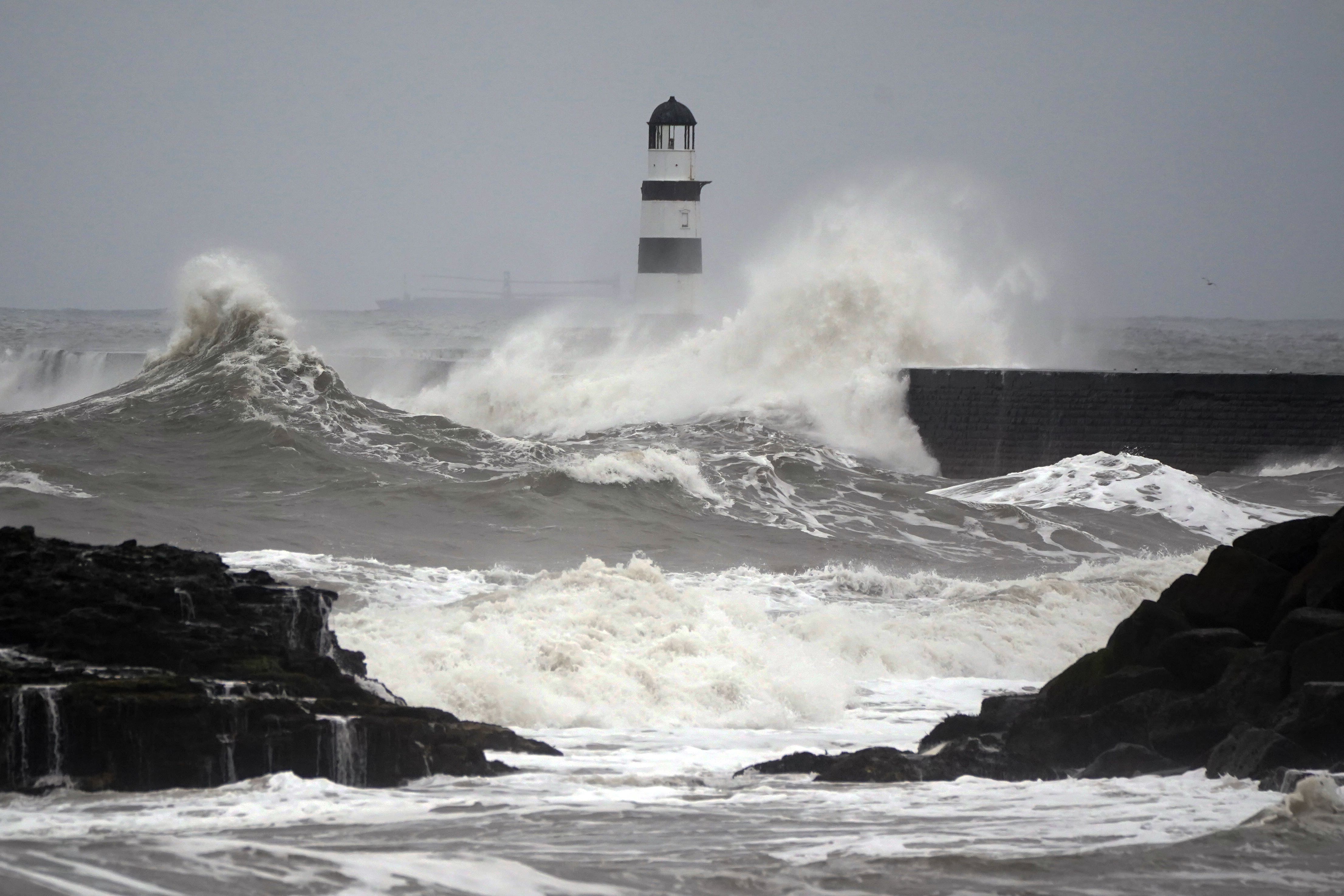Waves crash against the lighthouse in Seaham Harbour, County Durham (Owen Humphreys/PA)