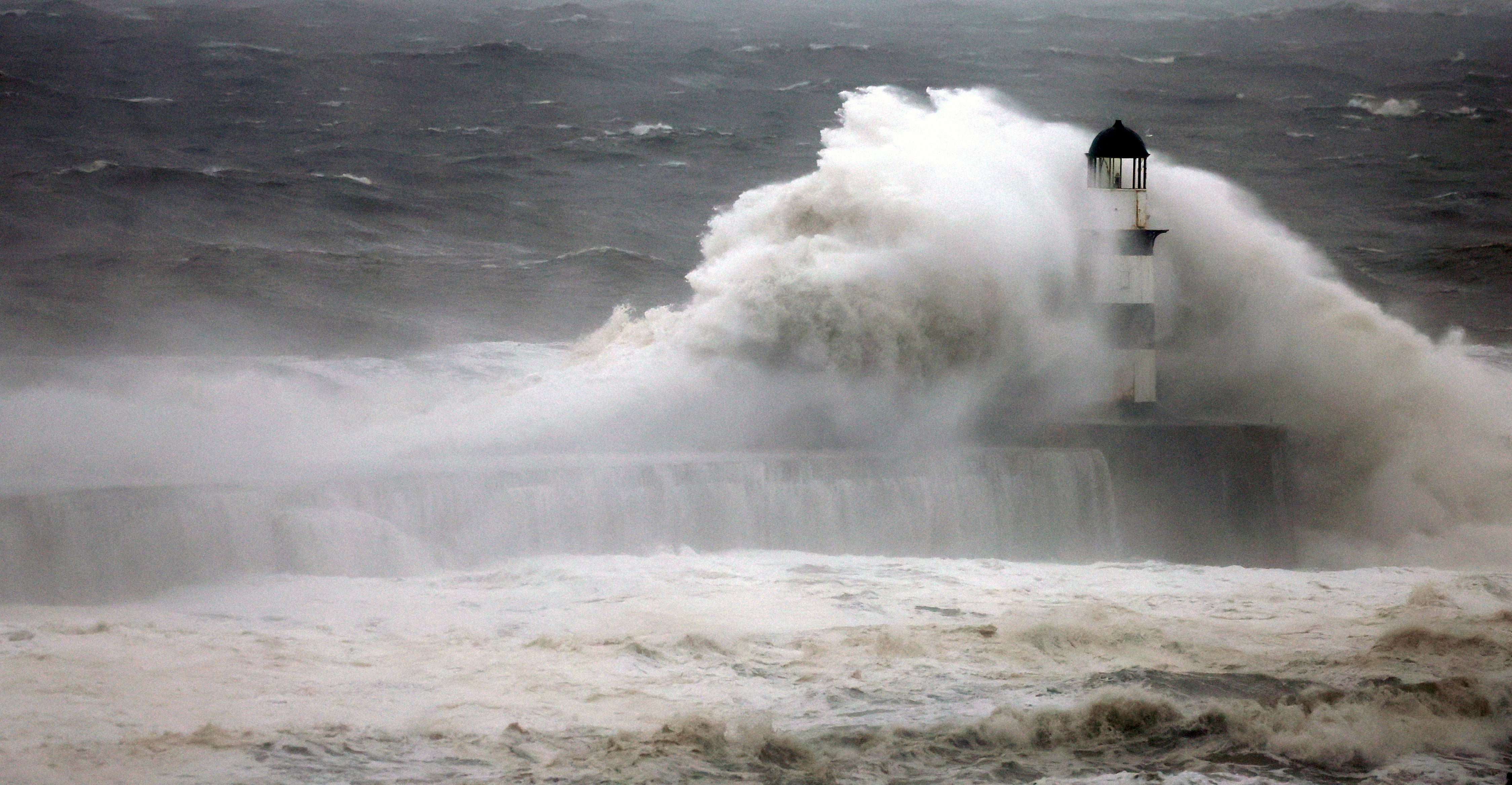 Waves crash against Seaham Lighthouse in County Durham during Storm Babet