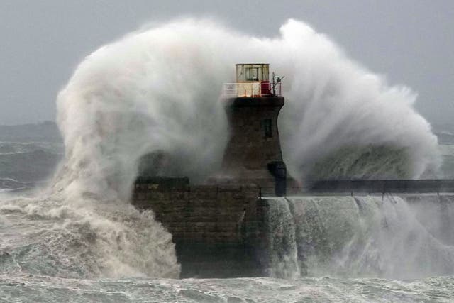 Waves crash against South Shields lighthouse after the top was ripped off as Storm Babet batters the country (Owen Humphreys/PA)