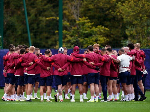 <p>The England players in a group huddle as they prepare for Saturday’s semi-final against the defending champions </p>