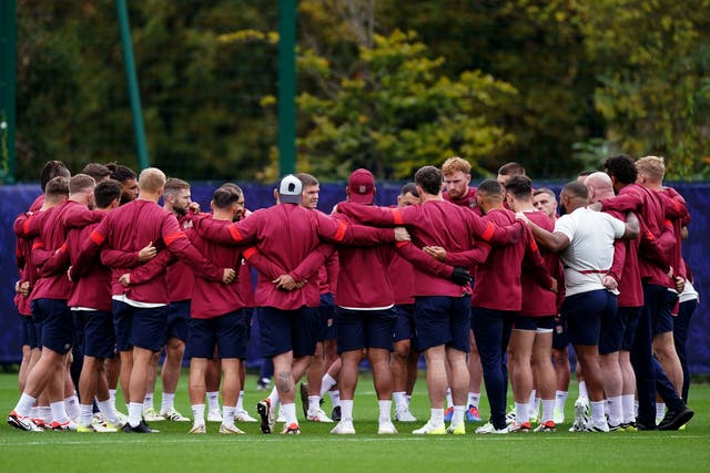 <p>The England players in a group huddle as they prepare for Saturday’s semi-final against the defending champions </p>