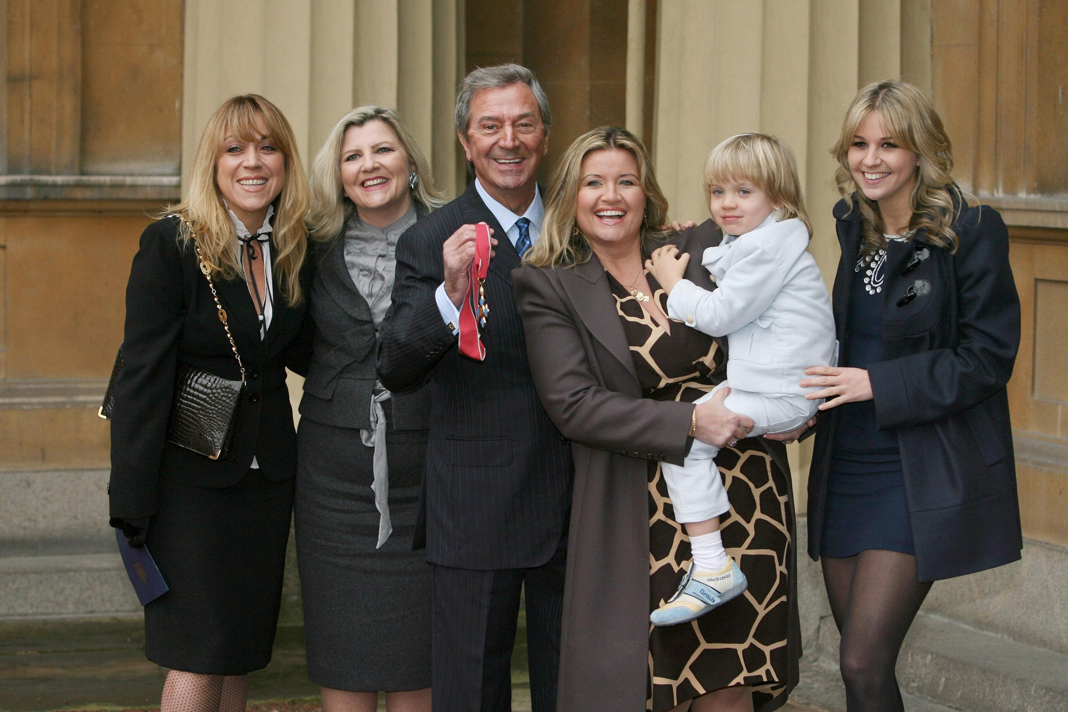 Kristina O’Connor (far right) with (from left) her half-sisters Samantha and Karen, father Des, stepmother Jodie, and half-brother Adam, after the entertainer received his CBE at Buckingham Palace in 2008