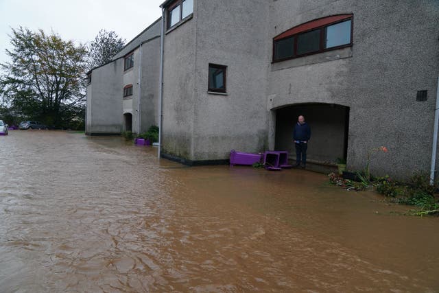A man views flood water in Brechin, Scotland, as Storm Babet batters the country (Andrew Milligan/PA)