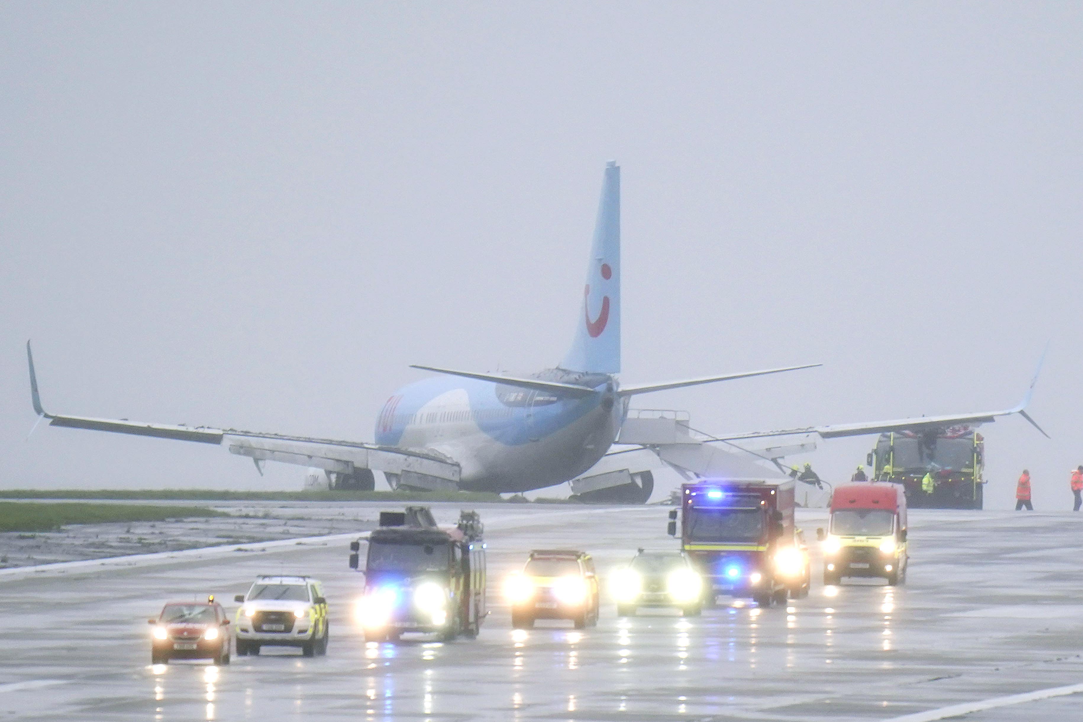 <p>Emergency services at the scene after a passenger plane came off the runway at Leeds Bradford Airport while landing in windy conditions during Storm Babet</p>