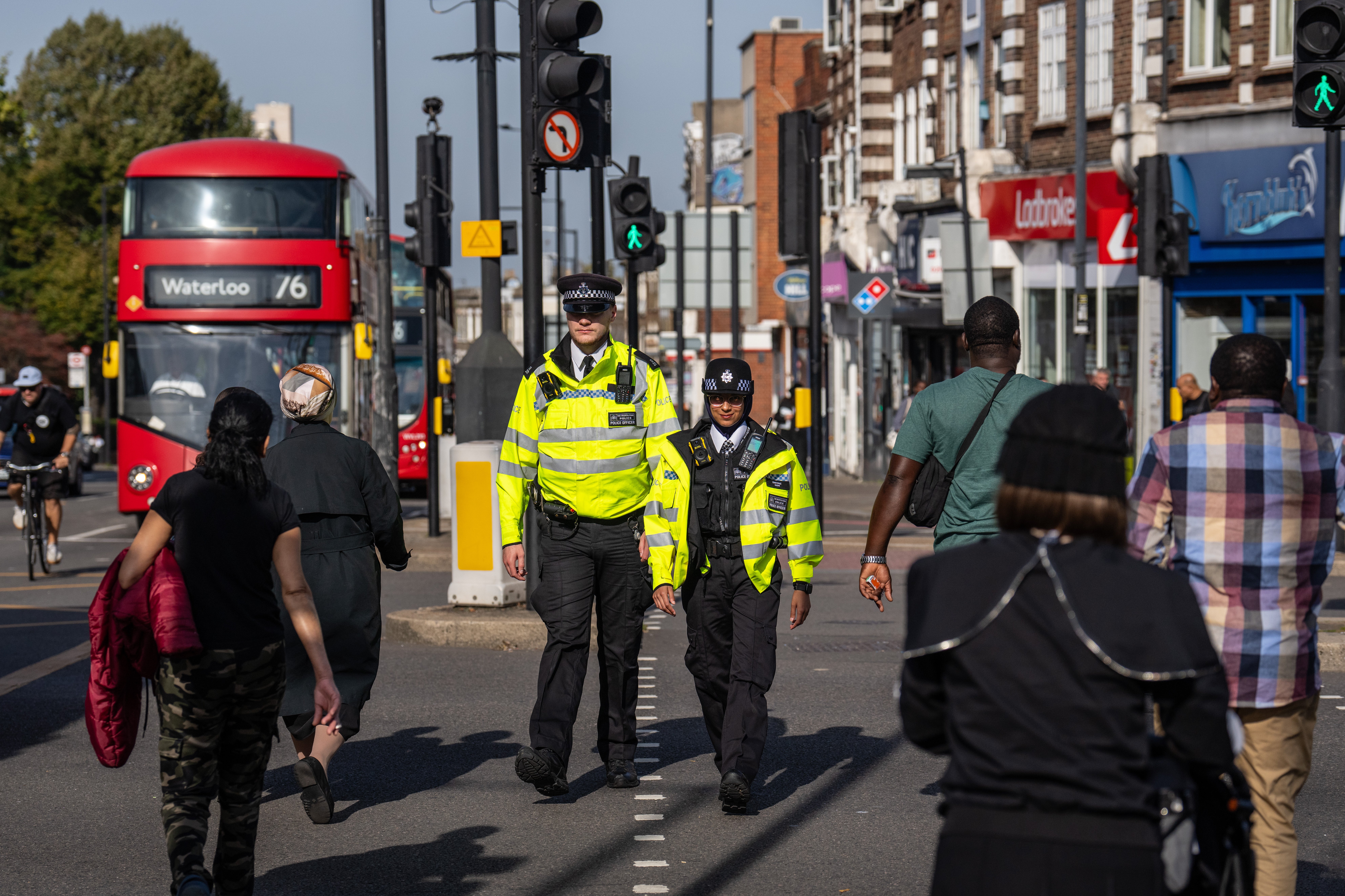 Police officers patrol through Stamford Hill, an area of London with a large Jewish community, in October
