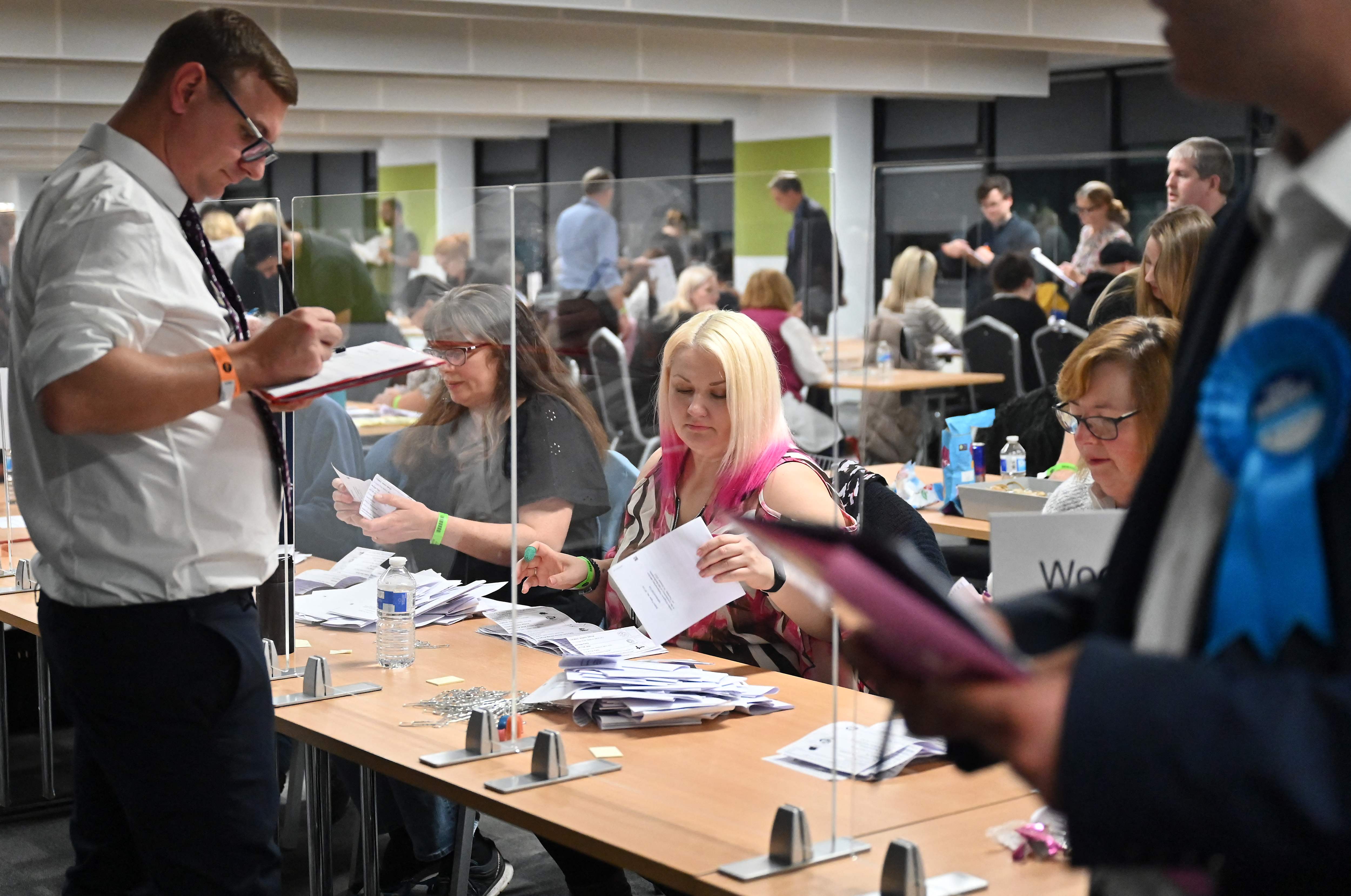 Counting agents observe as ballots are verified during the Mid Bedfordshire by-election