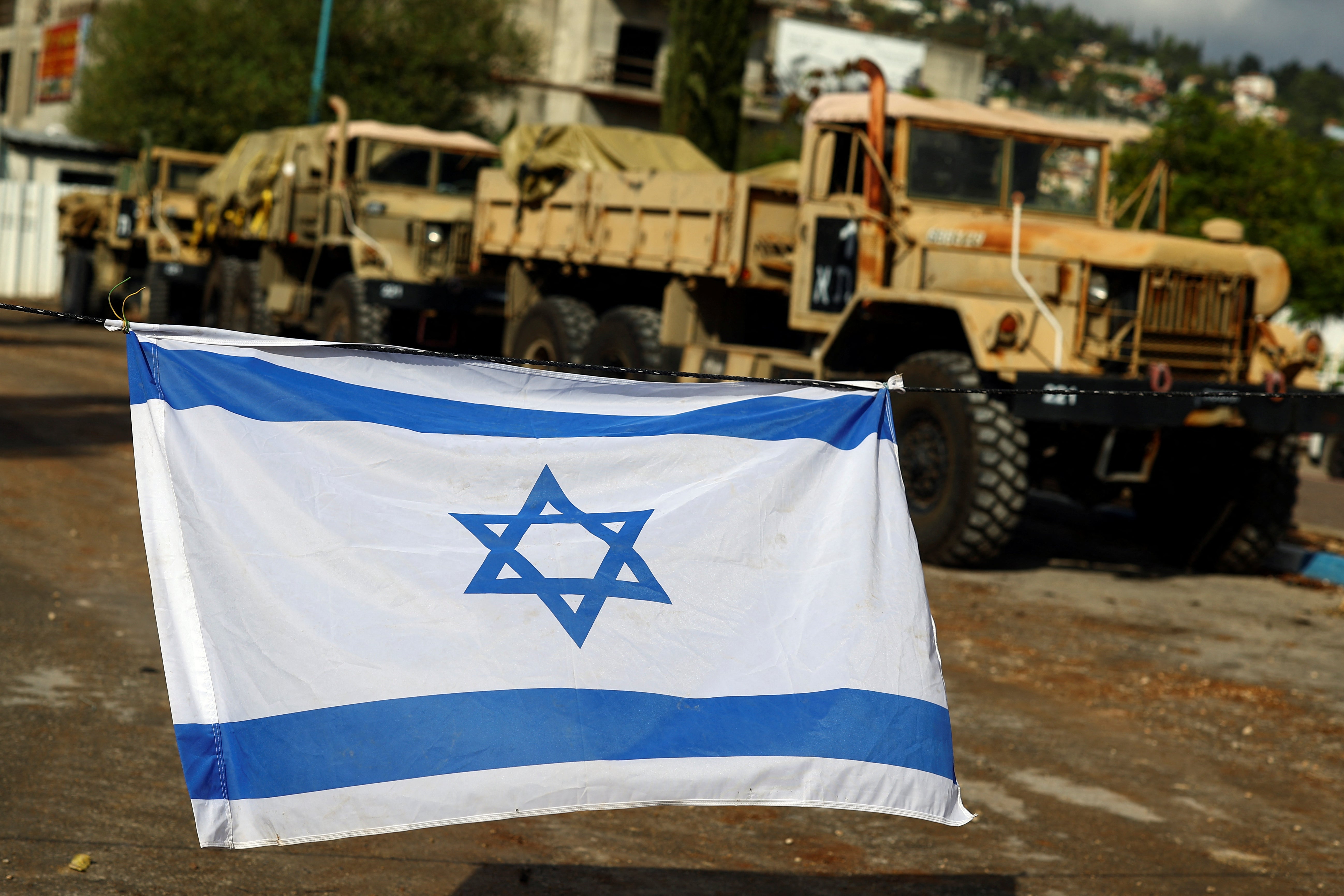 Israeli military vehicles gather near the border with Lebanon