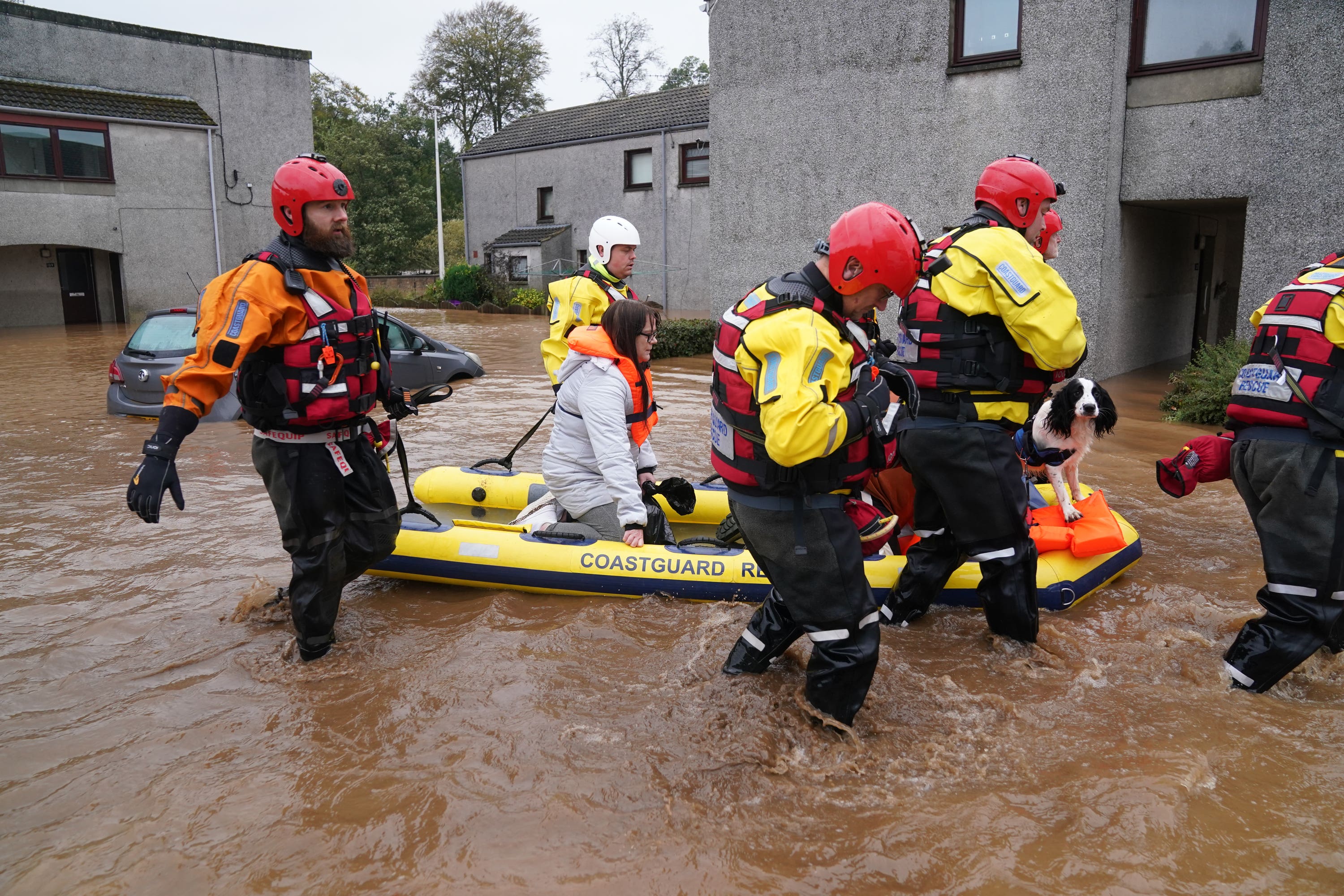 Members of the emergency services help local residents to safety in Brechin, Angus