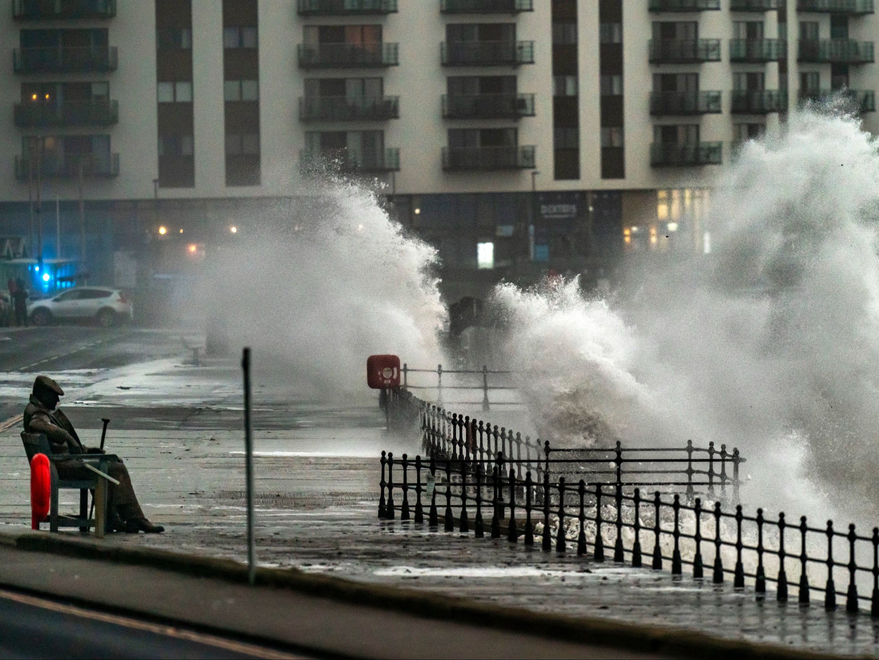 <p>Waves crash near to the 'Freddie Gilroy' sculpture by artist Ray Lonsdale in Scarborough, as Storm Babet batters the country</p>