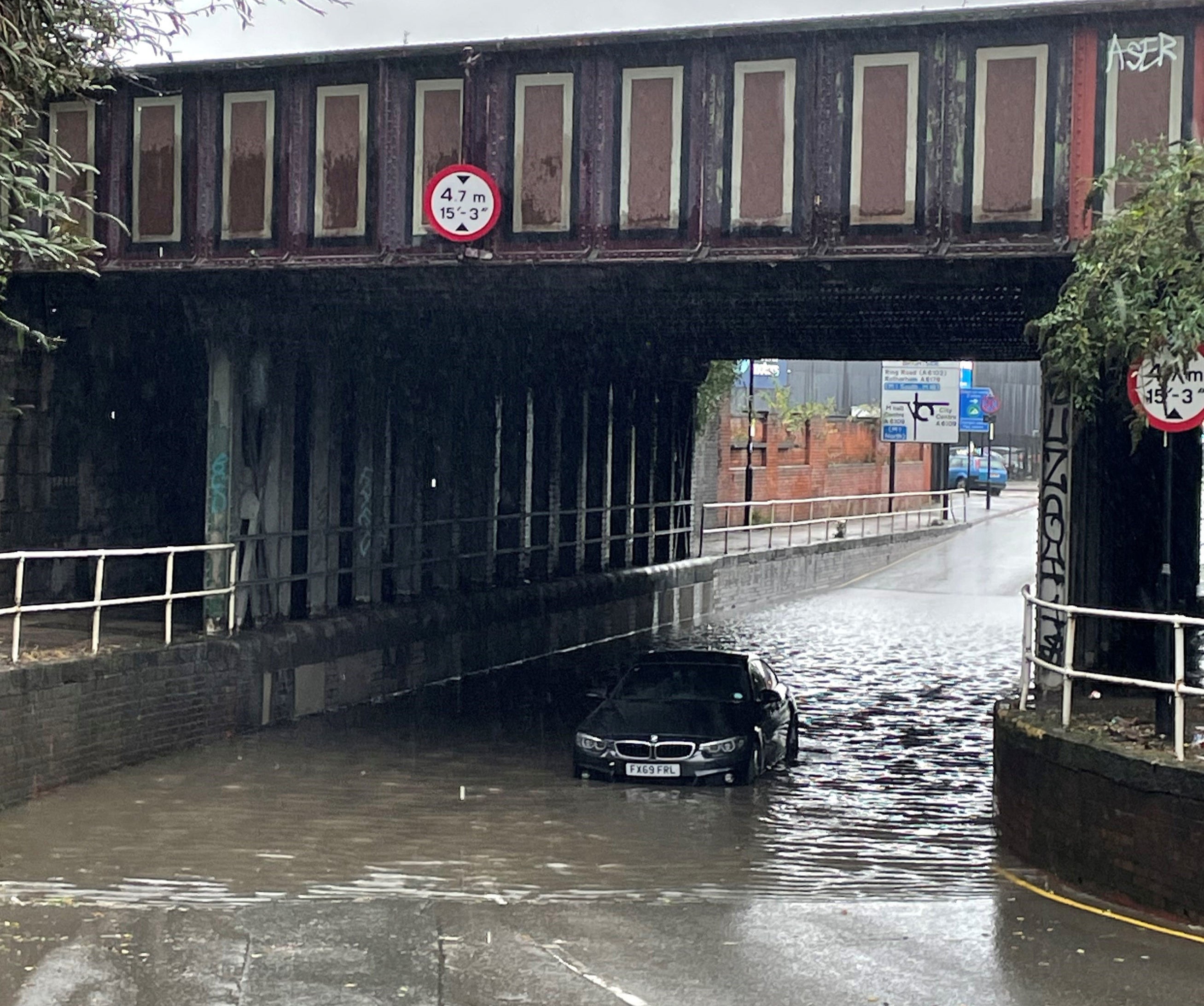 <p>File photo: A car stuck in floodwater under a railway bridge at Upwell Street, Sheffield </p>