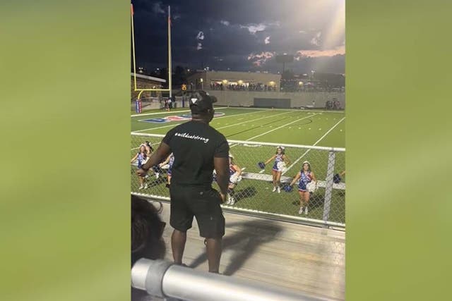 <p>A father dances in the stands while his daughter’s cheerleading team performs </p>