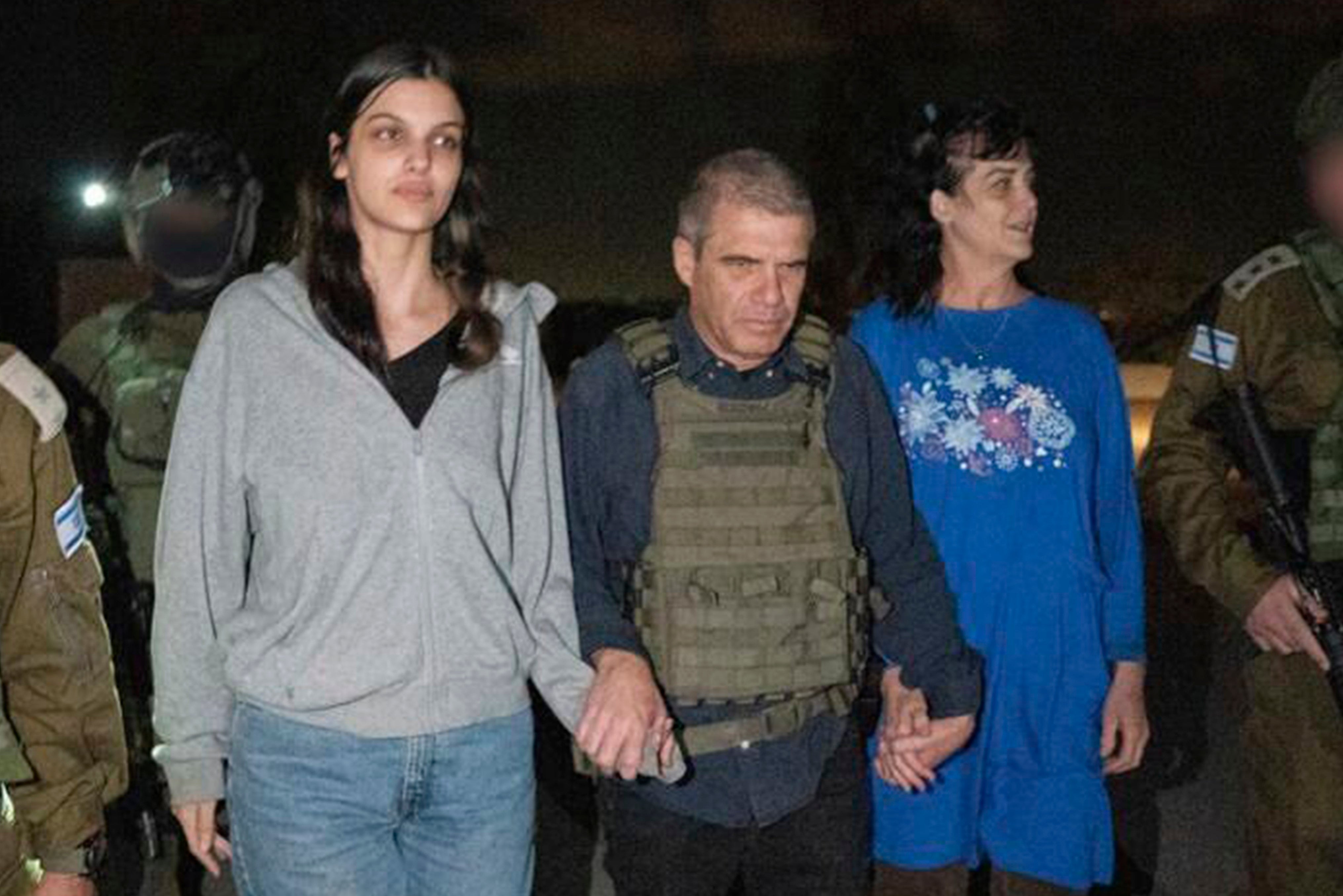 Judith Raanan, right, and her 17-year-old daughter Natalie are escorted by Israeli soldiers and Gal Hirsch, Prime Minister Benjamin Netanyahu's special coordinator for returning the hostages, as they return to Israel from captivity in the Gaza Strip